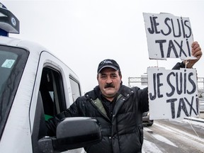 Montreal taxi driver Abdel Ghani marches toward the P.E. Trudeau Airport to protest against Uber, on Wednesday February 10, 2016, in Montreal, Quebec. One week ago the Steelworkers Union, which represents about 4,000 taxi drivers in Montreal, filed for an injunction to stop Uber from operating in Quebec.