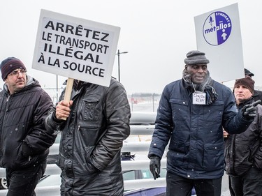 Montreal taxi drivers participate in a protest rally against Uber at Trudeau airport on Wednesday, Feb. 10, 2016.