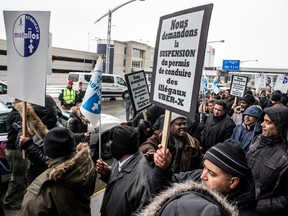 Montreal taxi drivers participate in a protest rally against Uber at Trudeau airport on Wednesday, Feb. 10, 2016.