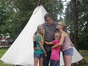 Stéphane Descheneaux with his three daughters, Marie-Lee, 11 , Emmy, 8, middle and right, Audrey-Ann, 13, in front of a teepee outside the Abenakis Museum Odanak Indian reserve near Sorel.