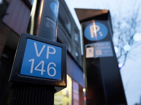 A parking spot marker and payment station in Montreal.