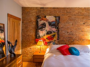 The bedroom at Johanne Giguère's home in the Plateau-Mont-Royal features a beautiful brick wall. (Dario Ayala / Montreal Gazette)