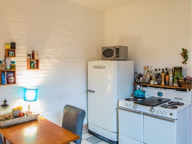 A view of the kitchen with an old General Electric fridge and gas stove in Johanne Giguere's condo in the Plateau. (Dario Ayala / Montreal Gazette)