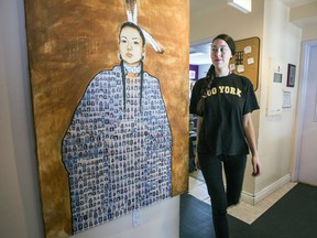 Frontline worker Tricia walks by a painting by native artist Jonathan LaBillois at the Native Women's Shelter in Montreal on Tuesday Feb. 02, 2016. The painting depicts missing and murdered indigenous women.