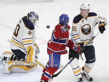 Buffalo Sabres goalie Robin Lahner makes a save as defenceman Rasmus Ristolainen ties up Montreal Canadiens David Desharnais during third period of National Hockey League game in Montreal Wednesday February 3, 2016.