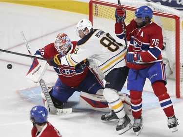 Buffalo Sabres Jamie McGinn tries to deflect the puck in front of Montreal Canadiens goalie Mike Condon and defenceman P.K. Subban as David Desharnais looks back during third period of National Hockey League game in Montreal Wednesday February 3, 2016.