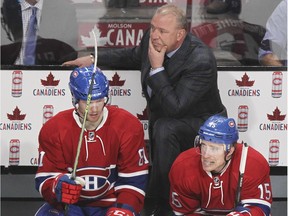 Montreal Canadiens coach Michel Therrien watches the action behind players Lars Eller, left and Tomas Fleischmann during a game against the Buffalo Sabres in Montreal Feb., 2016.