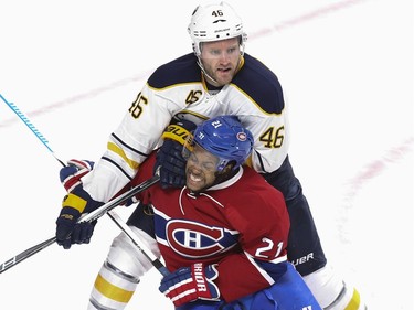 Montreal Canadiens Devante Smith-Pelly is checked by Buffalo Sabres Cody Franson  during first period of National Hockey League game in Montreal Wednesday February 3, 2016.