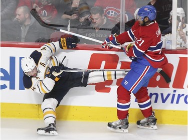 Montreal Canadiens Devante Smith-Pelley, right, runs into Buffalo Sabres Josh Gorges during third period of National Hockey League game in Montreal Wednesday February 3, 2016.