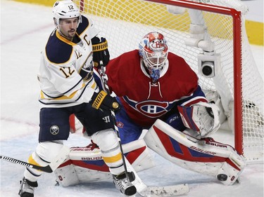Montreal Canadiens goalie Mike Condon and Buffalo Sabres Brian Gionta watch puck during National Hockey League game in Montreal Wednesday February 3, 2016.
