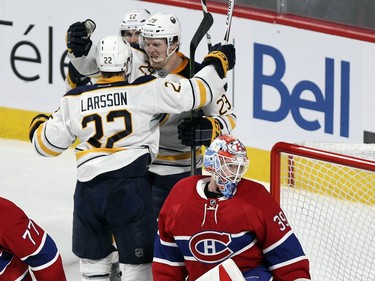 Montreal Canadiens goalie Mike Condon looks back at his net as Buffalo Sabres Jonas Larsson, Brian Gionta and Jake McCabe celebrate Larsson's game-winning goal during third period of National Hockey League game in Montreal Wednesday February 3, 2016.
