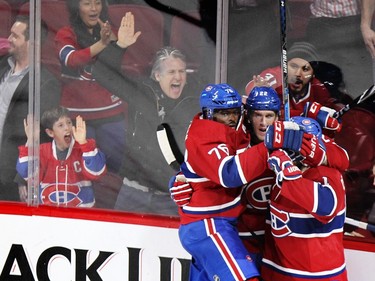 Montreal Canadiens P.K. Subban and David Desharnais, left, celebrate with Dale Weise after Weise's goal against the Buffalo Sabres during second period of National Hockey League game in Montreal Wednesday February 3, 2016.