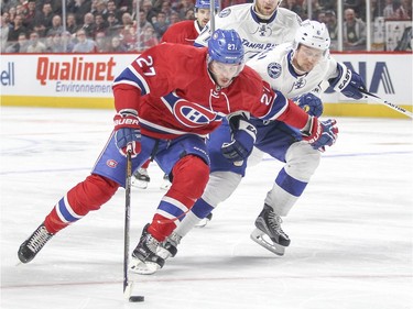 Montreal Canadiens Alex Galchenyuk holds off Tampa Bay Lightning Anton Stralman as Lightning's Victor Hedman and Canadiens Tomas Plekanec trail the play during third period of National Hockey League game in Montreal Tuesday February 9, 2016.