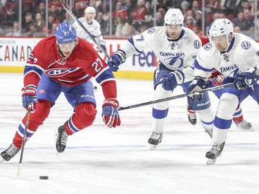 Montreal Canadiens Alex Galchenyuk is chased by Tampa Bay Lightning Anton Stralman, right and Victor Hedman during third period of National Hockey League game in Montreal Tuesday February 9, 2016.
