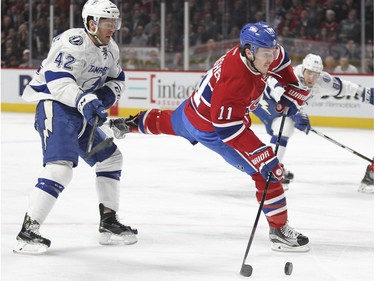 Montreal Canadiens Brendan Gallagher gets past Tampa Bay Lightning Jonathan Marchessault, left as he shoots the puck for the first goal of the game during first period of National Hockey League game in Montreal Tuesday February 9, 2016.