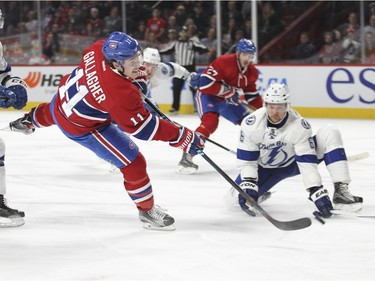 Montreal Canadiens Brendan Gallagher shoots the puck past Tampa Bay Lightning Jonathan Marchessault, left and Anton Stralman for the first goal of the game during first period of National Hockey League game in Montreal Tuesday February 9, 2016.