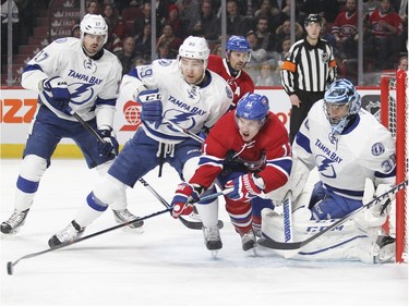 Montreal Canadiens Brendan Gallagher battles for the puck with Tampa Bay Lightning Nikita Nesterov, 2nd from left, in front of goalie Ben Bishop during first period of National Hockey League game in Montreal Tuesday February 9, 2016. Lightning's Alex Kilorn and Canadiens Tomas Plekanec watch the play in the background.