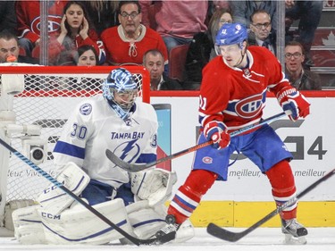 Montreal Canadiens Brendan Gallagher gets hit with a shot while standing in front of Tampa Bay Lightning goalie Ben Bishop during second period of National Hockey League game in Montreal Tuesday February 9, 2016.