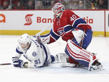 Montreal Canadiens goalie Ben Scrivens pushes Tampa Bay Lightning Steven Stamkos during second period of National Hockey League game in Montreal Tuesday February 9, 2016.