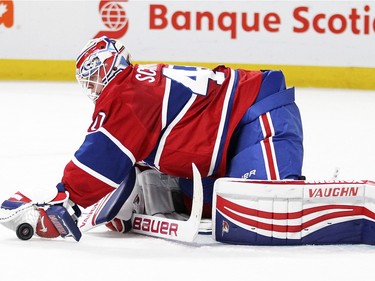 Montreal Canadiens goalie Ben scrivens covers up loose puck during second period of National Hockey League game against the Tampa Bay Lightning in Montreal Tuesday February 9, 2016.
