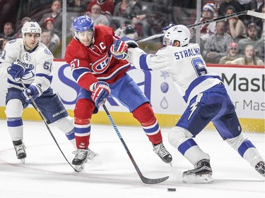 Montreal Canadiens Max Pacioretty is knocked off the puck by Tampa Bay Lightning Anton Stralman while also being pursued by Valtteri Filppula during third period of National Hockey League game in Montreal Tuesday February 9, 2016.