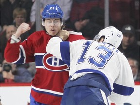 Canadiens Nathan Beaulieu, left, throws a punch at Cedric Paquette  of the Tampa Bay Lightning during first period of National Hockey League game in Montreal on Feb. 9, 2016.