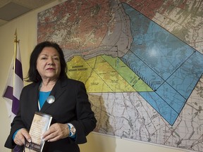 Chief Christine Zachary Deom, portfolio chief for the Seigneury Sault St-Louis Claim, stands in front of map depicting land claim in the Kahnawake band council chambers on  Monday Feb. 1, 2016.