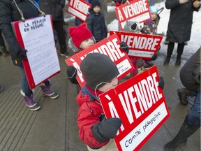 Four-year-old Sacha Belanger Mecteau with children, teachers, and parents from CPE Harmonie protest at the corner of de la Roche and Marie-Anne Sts. in Montreal, Monday February 1, 2016.