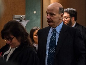 Frank Zampino, left, leaves room 5.05 at the corruption trial into the Contrecoeur real-estate development at the Palais de Justice in Montreal, on Wednesday, February 10, 2016.
