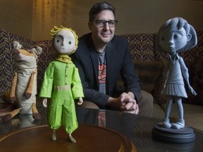 Mark Osborne, pictured with some of The Little Prince's characters, wanted his film to act as "a celebration of how the book works in our lives and how the book affects us."