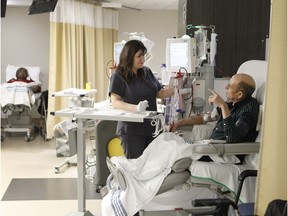 Dialysis patient Jose Pimentel, right, gets treatment while speaking with a nurse, Rodica Teleman, in the new dialysis centre at Lachine Hospital on Friday, Feb. 12, 2016. The centre was inaugurated on Friday by Quebec Health Minister Gaétan Barrette and Marquette MNA François Ouimet.