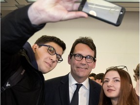 Parti Québécois leader Pierre Karl Peladeau poses for a selfie after speaking to students at Dawson College in Montreal, on Friday Feb. 12, 2016.