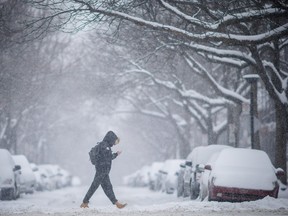 MONTREAL, QUE.: FEBRUARY 16, 2016 -- A man crosses the street near the intersection of Jarry street and Casgrain avenue during an early morning snowstorm in Montreal on Tuesday, February 16, 2016. The snow will give to freezing rain and rain later in the afternoon. (Dario Ayala / Montreal Gazette)