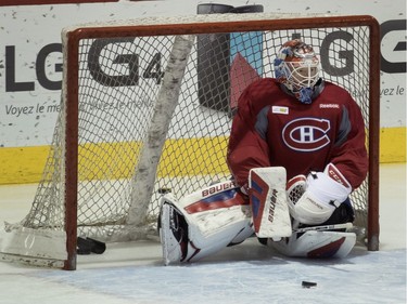 Montreal Canadiens goalie Mike Condon sits inside his net after being scored on by his teammates during team practice at the Bell Sports Complex in Montreal on Monday February 22, 2016.