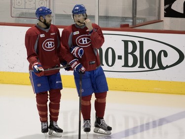 Montreal Canadiens left wing Lucas Lessio, left, and Montreal Canadiens defenseman Nathan Beaulieu speak at the start of a team practice at the Bell Sports Complex in Montreal on Monday February 22, 2016.