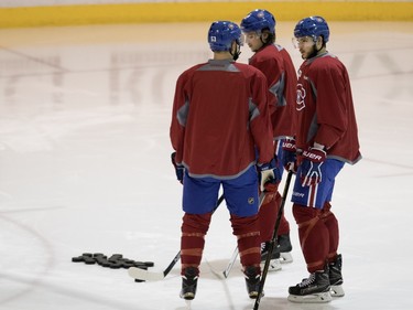 Montreal Canadiens left wing Lucas Lessio, left to right, Montreal Canadiens right wing Sven Andrighetto and Montreal Canadiens center Alex Galchenyuk speak before starting drills during team practice at the Bell Sports Complex in Montreal on Monday February 22, 2016.