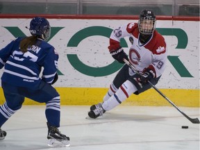 Marie-Philip Poulin looks for a clear player during  Canadian Women's Hockey League playoff game Saturday. Les Canadiennes beat the Toronto Furies 7-1.