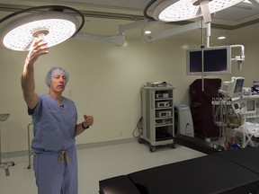 Orthopaedic surgeon Nicolas Duval adjust an operating room light, during walking tour of his Laval private medical facility on Wednesday February 3, 2016.