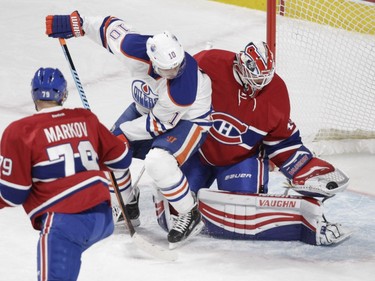 Goalie Ben Scrivens of the Montreal Canadiens makes a save with Nail Yakupov of the Edmonton Oilers in front of him in the first period of an NHL game at the Bell Centre in Montreal on Saturday, Feb. 6, 2016.