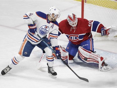 Goalie Ben Scrivens of the Montreal Canadiens makes a as Taylor Hall of the Edmonton Oilers looks for a rebound in front of him in the first period of an NHL game at the Bell Centre in Montreal on Saturday, Feb. 6, 2016.