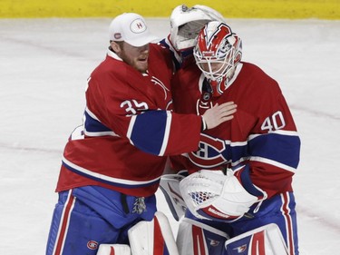 Goalie Ben Scrivens (right) of the Montreal Canadiens is congratulated by his back-up for the day, Mike Condon, after Scrivens beat the Edmonton Oilers in  an NHL game at the Bell Centre in Montreal on Saturday, Feb. 6, 2016.