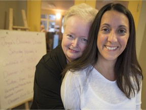 Joyce King, left, hugs Christine Harrison, the nurse who saved her life by performing CPR on her when she collapsed from a massive heart attack in a Pointe-Claire intersection just before Christmas. The pair met for the first time at a delayed Christmas dinner for King at her Beaconsfield residence on Saturday, February 6, 2016. (Peter McCabe / MONTREAL GAZETTE)