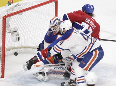 Tom Gilbert of the Montreal Canadiens scores his first goal of the season against goalie Anders Nilsson of the Edmonton Oilers in the third period of an NHL game at the Bell Centre in Montreal on Saturday, Feb. 6, 2016.