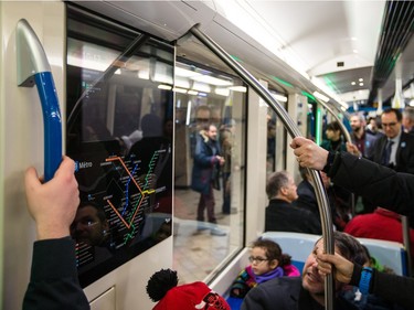 Passengers, security, and STM representatives ride the new AZUR metro train cars during the train's first public ride Sunday, February 7, 2016.