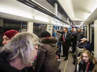 Passengers, security, and STM representatives ride the new AZUR metro train cars during the train's first public ride on the orange line in Montreal on Sunday, February 7, 2016.