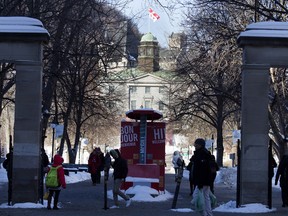 People enter and exit McGill University through the Roddick Gates in Montreal Jan. 20, 2016.