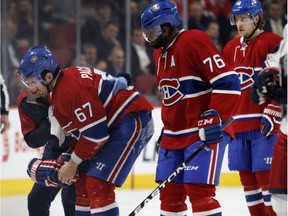 Canadiens left-wing Max Pacioretty, left, is taken off the ice after being hit in the head by a puck during NHL action against the Columbus Blue Jackets at the Bell Centre in Montreal on Tuesday, Jan,y 26, 2016.  Montreal Canadiens defenceman P.K. Subban and Montreal Canadiens defenseman Nathan Beaulieu, right, look on.