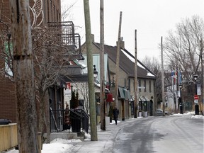 The main street in Ste-Anne-de-Bellevue village was closed to traffic most of the day on Thursday January 28 as Hydro crews took down the utility lines on the polls that line the south side of the street. (Marie-France Coallier / MONTREAL GAZETTE)