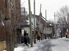 The utility lines were stripped from the poles on Ste-Anne St. in January. The poles will be removed in February, the final phase of remodelling the main street in Ste-Anne-de-Bellevue. (Marie-France Coallier/MONTREAL GAZETTE)