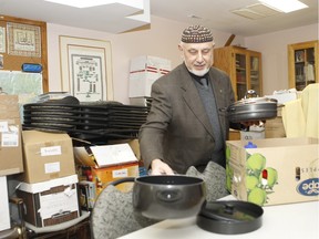 Mehmet Deger, president of Dorval Mosque, inspects all the donations received to help refugees start their new lives.The mosque has a room full of furniture, clothes and a variety of household items that have been donated. A new group, the West Island Refugee Network, has been established to co-ordinate efforts.  (Marie-France Coallier / MONTREAL GAZETTE)